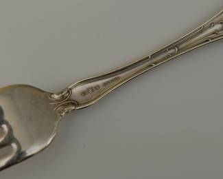 Closeup of a piece from antique R. Wallace & Sons sterling silver spoons and forks together with a baby spoon, in the "Violet" pattern, circa 1900