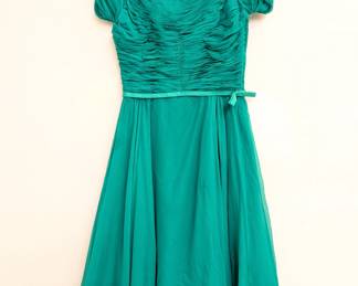 Vintage Nina Raynor party dress in vibrant emerald green, with scoop neck ruched bodice, cap sleeves, ribbon belt and a floaty full skirt.
