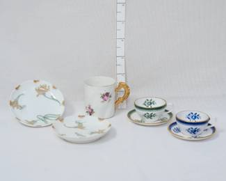 Two Haviland Limoges porcelain saucers in their lovely Art Nouveau "Schleiger 492-1" or "Spider Mum" pattern; two Spode miniature bone china cups and saucers, one with a green border and one with a blue border, both featuring a floral pattern and gold trim; and a porcelain coffee cut with molded diagonal surface, decorated with flowers and gilding