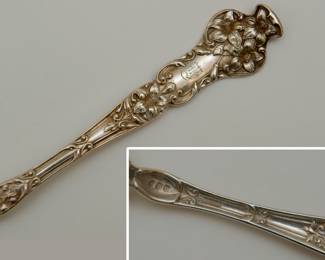 Closeup of silver forks and knives, 6 of each, with elaborate finely worked floral pattern