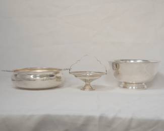 A double-handled silver plate serving bowl by The Sheffield Silver Co., a silver plate compote or footed basket with a top handle and a pierced border by El-Sil-Co, and a silver plated Paul Revere-style bowl by Wilcox International Silver Co.