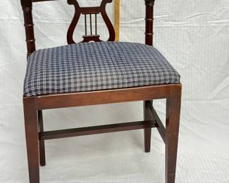 A Duncan Phyfe-style mahogany lyre-back chair with lion head pull, seat with plaid upholstery