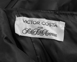 Closeup of vintage 1980s Victor Costa black velvet strapless dress with elaborate black silk taffeta bows neckline