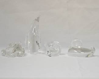 A signed Steuben crystal frog, designed by Lloyd Atkins; a signed Steuben art glass adult penguin figurine, a signed Steuben crystal glass snail designed by David Hills, and a Steuben crystal duck figurine