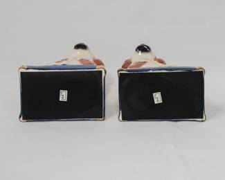 Another view of the vintage pair of Fritz and Floyd mirror image dog figurines, King Charles Spaniel dogs seated on cobalt blue gold tasseled cushions