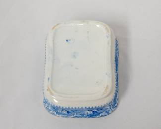 Another view of the antique blue and white transferware ceramic three-part soap dish  featuring a base, a removable inner drainer with holes, and a lid with a handle