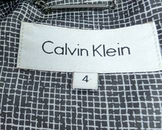 Closeup of the Calvin Klein women's one-button black blazer with rhinestone skull and crossbones design on the back, size 4