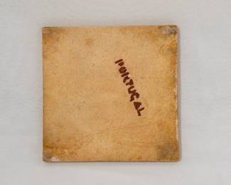 View of reverse of the hand-painted ceramic tile featuring a dog, with blue floral motifs in the corners and green grass at the bottom; crafted in Portugal