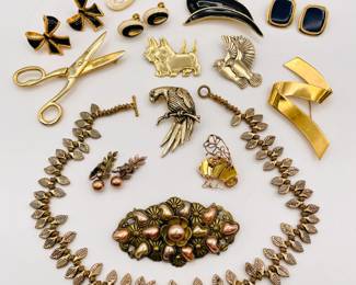 Fabulous and unique vintage costume jewelry including a choker necklace of layered leaves, a Monet gold-tone and pale enamel abstract floral brooch, a charming Scottish Terriers brooch (they're wearing little coats!), a Laurel Burch birds brooch, a pair of vintage KJL (Kenneth Jay Lane) for Avon black enamel and gold-tone bow earrings, pairs of Napier and Monet earrings, a delightfully stylized gold-tone bee brooch, a gold-tone scissors brooch, and more!