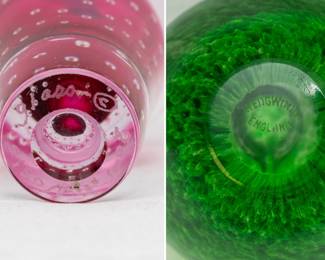 Closeup of the A stunning Lewis Olson signed studio art glass stoppered perfume bottle, clear with red and encased controlled bubble design, and a vintage Wedgwood hand-blown green art glass apple paperweight