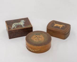 Three vintage wooden hand-painted trinket boxes, each with the portrait of a dog on the lid. Two of the boxes are marked on the base with "hand painted in England by: Winston Yeatts of Warwickshire for: Devonshire"