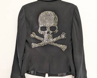 Another view of the Calvin Klein women's one-button black blazer with rhinestone skull and crossbones design on the back, size 4