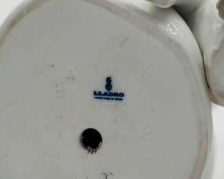 Closeup of base of ​​the Lladro 'Boy with Dog' porcelain figurine No. 4522 GLOSS. Base marked with LLADRO Handmade in Spain. Measures 7-1/2 inches H. Head reattached.