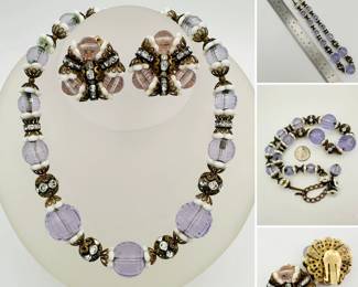 A lovely Hobe demi-parure consisting of a necklace and matching earrings comprised of various styles of beads including faceted Lucite, rhinestone roundelles, and white glass and brass floral caps. Necklace is adjustable from 16" to 18" in length.