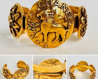 A vintage Chanel gold tone lion medallion bangle bracelet
