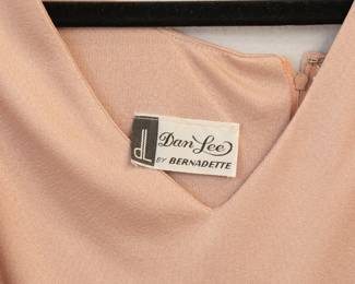 Closeup of Dan Lee by Bernadette vintage peach color pleated maxi dress, zipper back