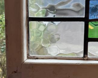 M3 - $75. Stained Glass with hooks to hang in the window. Measures 20" x 15". Has crack & hole in top center clear panel. 