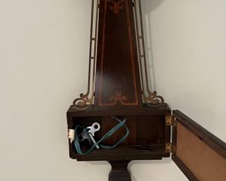 M46 - $25. Sessions Clock. Eight Day Lever Time. Mahogany Finish Case. Measures 7.5" wide x 23.5" tall. 