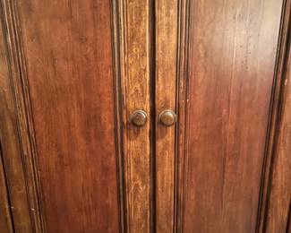 M104 - $100. Entertainment Center by Universal Furniture. Measures 59" wide x 23" deep x 69" tall. Located right inside the front door - PLEASE have help to move this. 