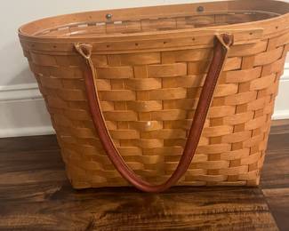M69 - $40. 2005 Longaberger Large Boardwalk Basket with Leather Handles. Has plastic insert. Measures 18" wide x 10" x  12" tall (+ handles.)