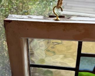 M3 - $75. Stained Glass with hooks to hang in the window. Measures 20" x 15". Has crack & hole in top center clear panel. 