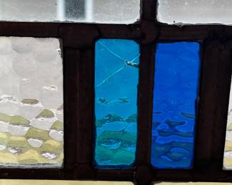 M1 - $75. Stained Glass with Hooks to Hang in the Window. Measures 20" x 14.25". One crack in a light blue pane. 