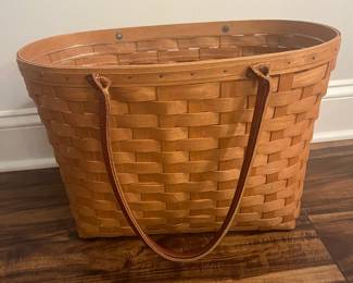 M69 - $40. 2005 Longaberger Large Boardwalk Basket with Leather Handles. Has plastic insert. Measures 18" wide x 10" x  12" tall (+ handles.)