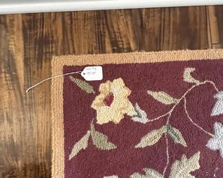 M52 - $50. Capel Runner. Measures 95" x 29". "Antique Florals in Mahogany". Has been used inside the front door so it does show some signs of wear 