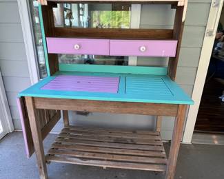 M77 - $75. Teak Potting Bench. Metal hinges do have rust. Has been used / store in a covered screened in porch. Measures 42" wide x 23" deep x 57" tall. Leaf adds 19.5". Does wiggle a bit and could use some tightening up. 