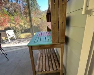 M77 - $75. Teak Potting Bench. Metal hinges do have rust. Has been used / store in a covered screened in porch. Measures 42" wide x 23" deep x 57" tall. Leaf adds 19.5". Does wiggle a bit and could use some tightening up. 