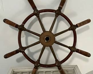 M43 - $175. 24" Ships Wheel. Brass with Wood Handles Ships Wheel with the name Gen. & Mar. Tr. Amsterdam in the middle. Measures 24" across.  