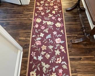 M52 - $50. Capel Runner. Measures 95" x 29". "Antique Florals in Mahogany". Has been used inside the front door so it does show some signs of wear 