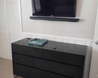 Black dresser; TV with mounting bracket; sound bar