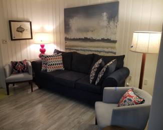 Navy sofa with matching loveseat; end table; table lamp; floor lamp