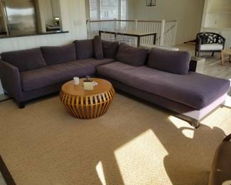 Contemporary sectional couch; sisal area rug woven in Belgium; West Elm coffee table