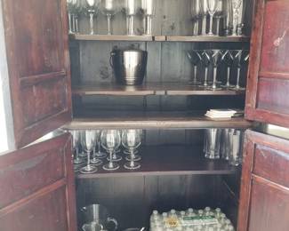 Asian storage armoire interior; stemware and barware