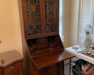 #17 Chippendale-style "mahogany" secretary bookcase with slant front writing desk. Ball and claw feet. 3 drawers, 2 doors, 2 shelves. (79h x 29w x 16d) $165.00