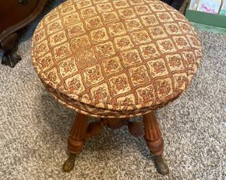 #13 Antique Holtzman and Sons Piano Stool with brass foot and carved wood. - adjustable. As is wea and repairs.. Restored in 1972. 20.5"tall (adjustable lower) 19.5 width $65.00