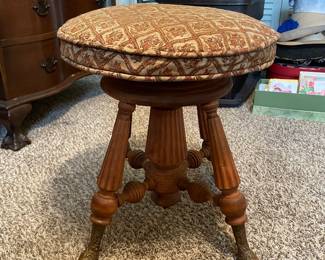 #13 Antique Holtzman and Sons Piano Stool with brass foot and carved wood. - adjustable. As is wea and repairs.. Restored in 1972. 20.5"tall (adjustable lower) 19.5 width $65.00