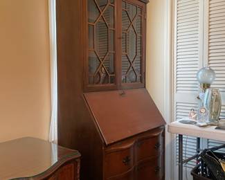 #17 Chippendale-style "mahogany" secretary bookcase with slant front writing desk. Ball and claw feet. 3 drawers, 2 doors, 2 shelves. (79h x 29w x 16d) $165.00