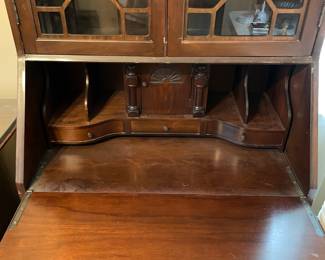 #17 Chippendale-style "mahogany" secretary bookcase with slant front writing desk. Ball and claw feet. 3 drawers, 2 doors, 2 shelves. (79h x 29w x 16d) $165.00