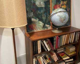 Lots of books, wall art, solid wood bookshelf, floor lamp