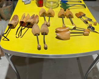Great vintage yellow table and collection of shoe stretchers