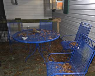 Wrought iron table with 4 rocker chairs