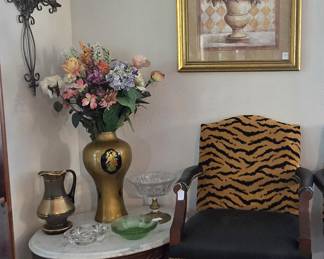 set of 2 animal print bar stools, oval marble-topped antique table with an ornate Mahogany base, beautiful vase of flowers next to a stunning Bohemian Crystal pitcher on one side, and an extremely heavy lead crystal candy dish on the other.