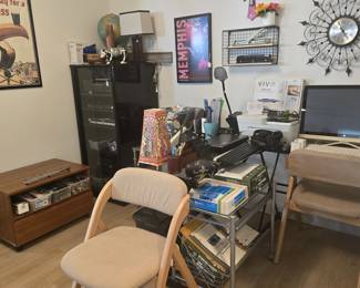 Small scale, glass-top "L" shaped desk, print stand, printer, 2 folding, padded chairs, stereo cabinet, framed posters, office supplies and more! 