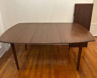 Wooden dining room table 4 x 4 ft with 2 18 inch wide leaves.