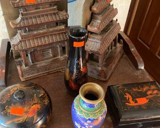 Chinese lacquer trinket box with a hand-painted goldfish design.
Chinese cloisonné vase
vintage Japanese lacquerware jewelry box
miniature pagoda, which is a type of Asian architectural model.