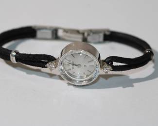 Vintage Omega Ladies' Wristwatch with a 14kt white gold case, diamond accented lugs and a black cord style band, 5.5" long, 7.44 grams total weight