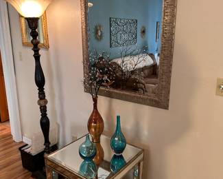 Golden Framed Mirror 
Mirrored Accent Table
Beautiful Floor Lamp
Art Glass Vases